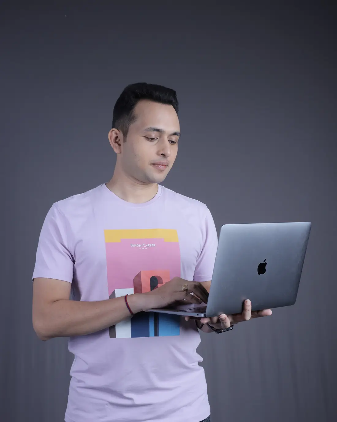 Sagar Sangam Sahu holding an open laptop